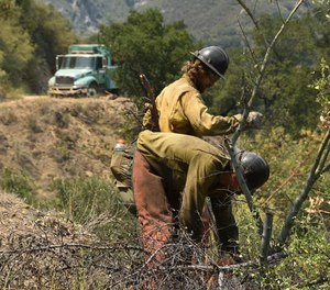 Firefighters work in steep terrain at the Willow Fire near Big Sur, Calif. Firefighters still face the difficult task of trying to contain a large forest fire in rugged coastal mountains south of Big Sur that forced the evacuation of a Buddhist monastery and nearby campground.