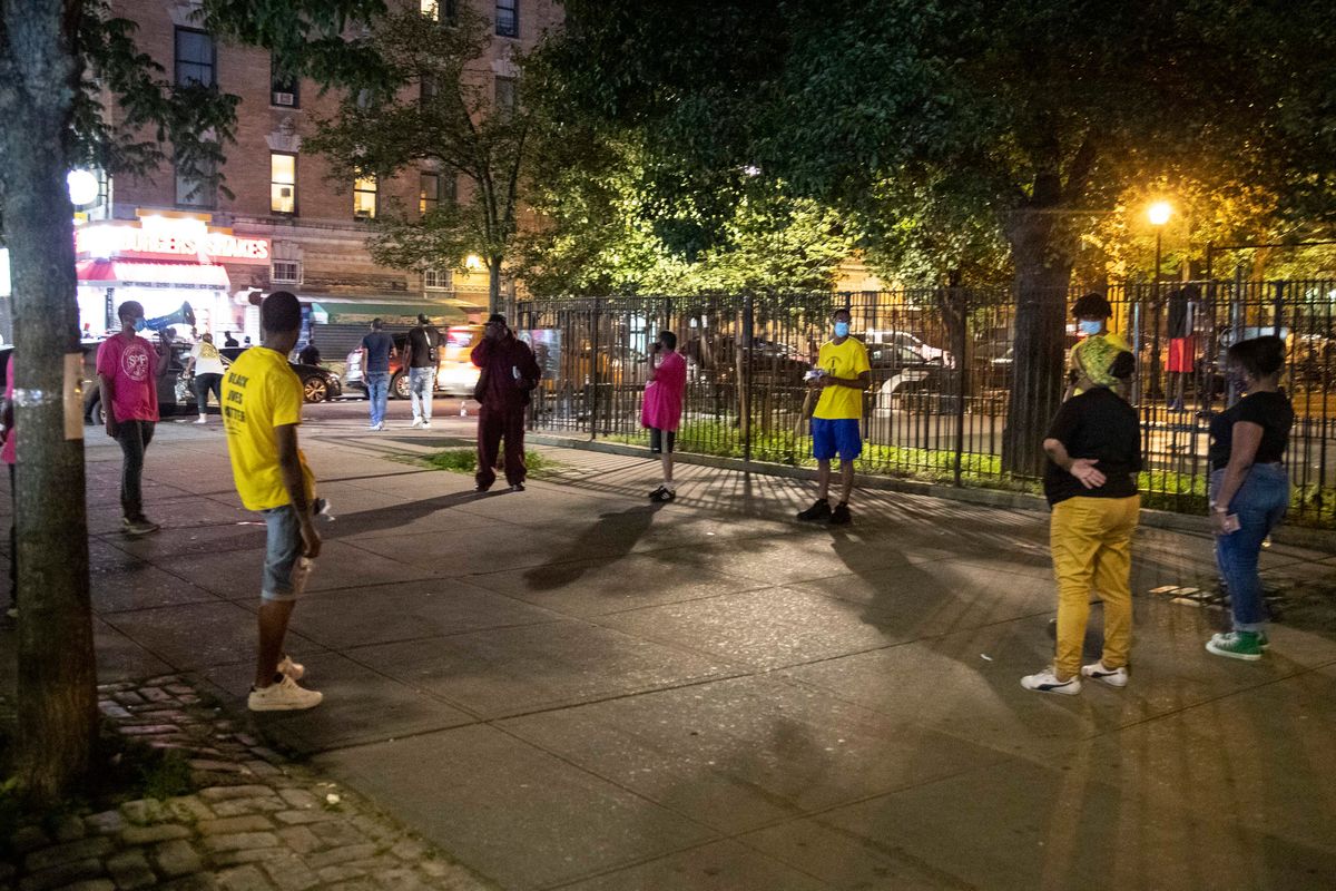 In this Saturday, July 18, 2020, file photo, Iesha Sekou, second from right, founder and CEO of Street Corner Resources, leads young men to 