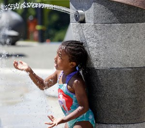 Mellena O'Brien, 4, plays in the Yesler TerraceSpray Park during a heat wave hitting the Pacific Northwest, Sunday, June 27, 2021, in Seattle.