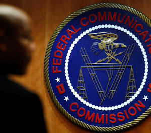This Dec. 14, 2017, file photo, shows the seal of the Federal Communications Commission (FCC) before a meeting in Washington.