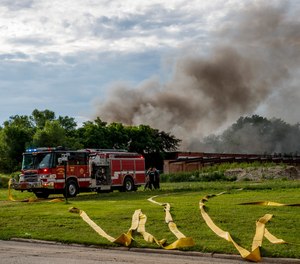 Firefighters work the scene of an industrial fire Tuesday, June 29, 2021, in Morris, Ill. Lithium batteries have been noisily exploding inside a burning abandoned paper mill in northern Illinois and firefighters are letting the blaze burn out because they fear trying to extinguish it could trigger more explosions, officials said Wednesday.