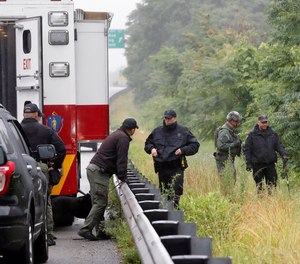 Police work in the area of an hours long standoff with a group of armed men that partially shut down interstate 95, Saturday, July 3, 2021, in Wakefield, Mass.