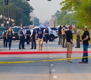 Chicago police and ATF agents work the scene of a shooting on South Ashland Avenue near West 118th Street next to Interstate 57.