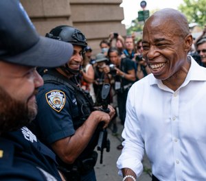 Brooklyn Borough President and a Democratic mayoral candidate Eric Adams greets NYPD officers as participants gather for a march through the financial district during a parade honoring essential workers for their efforts in getting New York City through the COVID-19 pandemic, Wednesday, July 7, 2021, in New York.