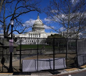 In this April 2, 2021, file photo the U.S. Capitol is seen behind security fencing on Capitol Hill in Washington.