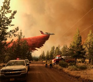 This photo provided by the Oregon Department of Forestry shows a firefighting tanker making a retardant drop over the Grandview Fire near Sisters, Ore., Sunday, July 11, 2021. The wildfire doubled in size to 6.2 square miles (16 square kilometers) Monday, forcing evacuations in the area, while the state's biggest fire continued to burn out of control, with containment not expected until November