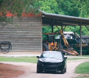 In this June 8, 2021, file photo, a vehicle sits in the driveway of a home in rural Colleton County, S.C., where a mother and son from a prominent South Carolina legal family were found shot and killed.