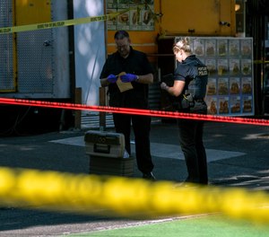 Police investigate an overnight shooting Saturday, July 17, 2021 in Portland, Ore. Police said one person died and at least six people were injured in an early morning shooting Saturday in Portland, Oregon.