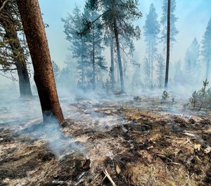 In this photo provided by the Bootleg Fire Incident Command, the Bootleg Fire is seen smoldering in southern Oregon, Saturday, July 17, 2021. The destructive Bootleg Fire, one of the largest in modern Oregon history, has already burned more than 476 square miles (1,210 square kilometers), an area about the size of Los Angeles. Meteorologists predicted critically dangerous fire weather through at least Monday with lightning possible in both California and southern Oregon.