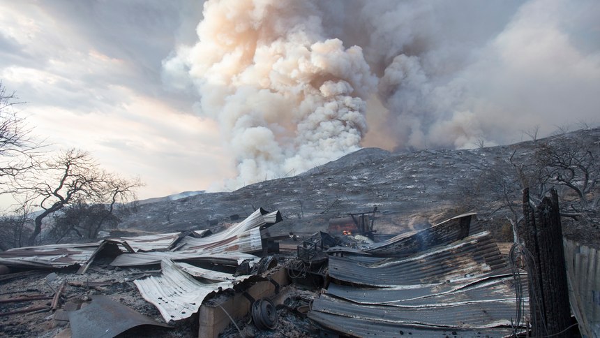 a burned structure is seen at a wildfire in Yucaipa, Calif. A couple whose gender reveal ceremony sparked the Southern California wildfire that killed a firefighter in 2020 have been charged with involuntary manslaughter.