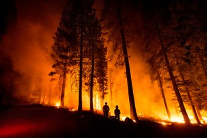 Cal Fire Capts. Derek Leong (right) and Tristan Gale monitored a firing operation, where crews set a ground fire to stop a wildfire from spreading, while battling the Dixie Fire in Lassen National Forest, Calif., on July 26, 2021. Recently, the Forest Service warned employees that it was unable to fill about 1,000 temporary firefighter positions and was now looking to make emergency hires by shortening the onboarding process.