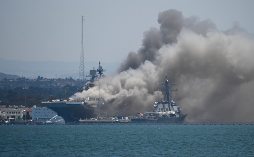 Smoke rises from the USS Bonhomme Richard at Naval Base San Diego after an explosion and fire Sunday on board the ship at Naval Base San Diego.