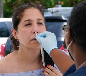Federal health officials say Florida has reported 21,683 new cases of COVID-19, the state's highest one-day total since the start of the pandemic.
