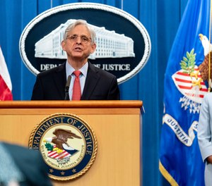 Attorney General Merrick Garland, accompanied by Assistant Attorney General for Civil Rights Kristen Clarke, right, speaks at a news conference at the Department of Justice in Washington, Thursday, Aug. 5, 2021, to announce that the Department of Justice is opening an investigation into the city of Phoenix and the Phoenix Police Department.