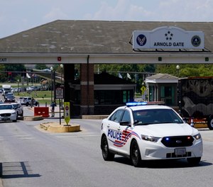 A Metropolitan Police Department cruiser drives out of an entrance to Joint Base Anacostia-Bolling during a lockdown, Friday, Aug. 13, 2021, in Washington.