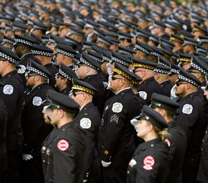 Chicago police and firefighters salute as the body of slain Chicago police officer Ella French is carried into the St. Rita of Cascia Shrine Chapel for a funeral service Thursday, Aug. 19, 2021, in Chicago.