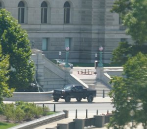 A pickup truck is parked on the sidewalk in front of the Library of Congress' Thomas Jefferson Building, as seen from a window of the U.S. Capitol, Thursday, Aug. 19, 2021, in Washington.