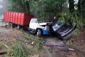 A truck and a car sit in a creek Sunday, Aug. 22, 2021, after they were washed away the day before in McEwen, Tenn. Heavy rains caused flooding in Middle Tennessee and have resulted in multiple deaths as homes and rural roads were washed away.