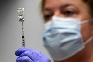 Pharmacy Technician Hollie Maloney loads a syringe with Pfizer's COVID-19 vaccine. The U.S. gave full approval to Pfizer's COVID-19 vaccine on Monday, Aug. 23, 2021.