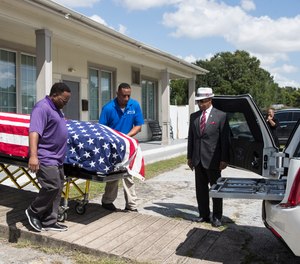 The body of New Orleans Police detective Everett Briscoe is placed into a hearse before it is escorted from the Respect for Life Funeral Home for the journey back to New Orleans, Tuesday, Aug. 24, 2021, in Houston.