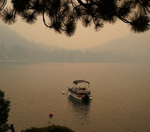 Smoke from the Caldor Fire, shrouds Fallen Leaf Lake near South Lake Tahoe, Calif., Tuesday, Aug. 24, 2021. The massive wildfire, that is over a week old, has scorched more than 190 square miles, (492 square kilometers) and destroyed hundreds of homes since Aug. 14. It is now less than 20 miles from Lake Tahoe.