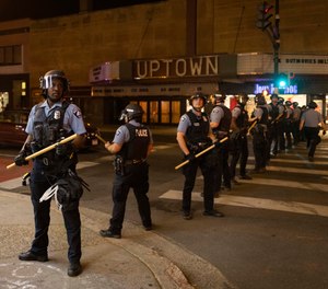 In this June 5, 2021, file photo, Minneapolis police officers stand in formation after a vigil for Winston Boogie Smith Jr. in Minneapolis.
