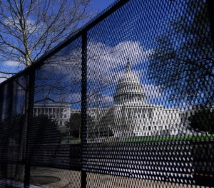 In this April 2, 2021, file photo, the U.S. Capitol is seen behind security fencing on Capitol Hill in Washington.