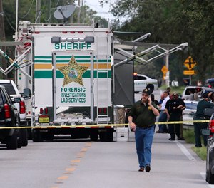 Polk County, Fla., Sheriff's officials work the scene of a multiple fatality shooting Sunday, Sept. 5, 2021, in Lakeland, Fla. Four people are dead including a mother who was still cradling her now deceased baby in what Florida sheriff's deputies are calling a massive gun battle with a suspect.