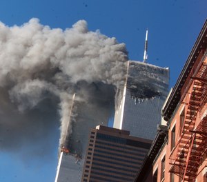 Smoke rises from the burning twin towers of the World Trade Center after hijacked planes crashed into the towers on September 11, 2001 in New York City.