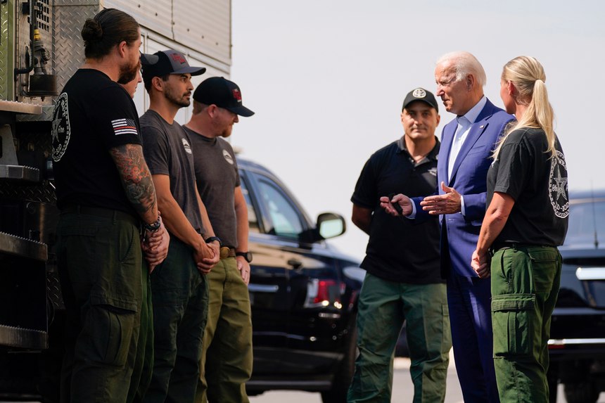 President Joe Biden greets firefighters as he tours the National Interagency Fire Center in Boise, Idaho.