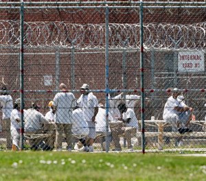 In this June 25, 2020, photo, prisoners populate a yard at the Nebraska State Penitentiary in Lincoln, Neb.