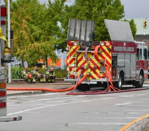 Firefighters take a break by the Ambassador Bridge border crossing in Windsor, Ontario.