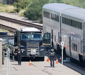 A Tucson Police Department SWAT truck is parked near the last two cars of an Amtrak train in downtown Tucson, Ariz., Monday, Oct. 4, 2021.