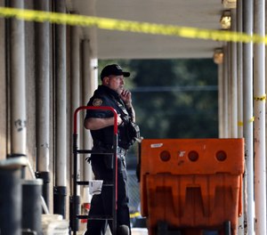 Memphis Police Department officers work the scene of a post office after a shooting, Tuesday, Oct. 12, 2021 in the Orange Mound neighborhood of Memphis, Tenn.