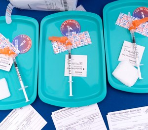 In this May 19, 2021 file photo, Pfizer COVID-19 vaccine doses are prepared for members of the community 12 years and up, at a clinic held by Community of Hope, outside the Washington School for Girls in southeast Washington.