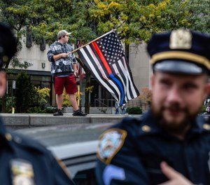 New York City municipal workers protest outside City Hall against the coming COVID-19 vaccine mandate, Monday, Oct. 25, 2021, in New York. New York City employees are required to show proof of at least one vaccine dose by Friday, Oct. 29.