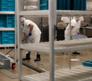 In this Sept. 10, 2019, workers are shown in the kitchen of the U.S. Immigration and Customs Enforcement (ICE) detention facility in Tacoma, Wash.