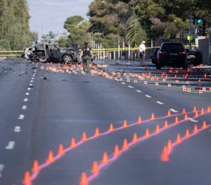 Las Vegas Metro Police investigators work at the scene of a fatal crash Tuesday, Nov. 2, 2021, in Las Vegas. Police in Las Vegas say Las Vegas Raiders wide receiver Henry Ruggs III was involved in the fiery vehicle crash early Tuesday that left a woman dead and Ruggs and his female passenger injured.