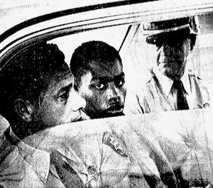 In this February 1964 photo, Henry Montgomery, flanked by two deputies, awaits the verdict in his trial for the murder of Deputy Sheriff Charles H. Hurt in Louisiana.