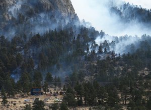 The Kruger Rock fire was burning in Estes Park, Colo., on Nov. 16. Work for the State Wildland Inmate Fire Team includes clearing dead or dying trees and fighting wildfires.