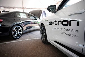 A 2021 Audi e-tron (right) sits on display at the Denver auto show on Sept. 17, 2021. The e-tron could get Audi's newly patented in-battery fire prevention technologies.