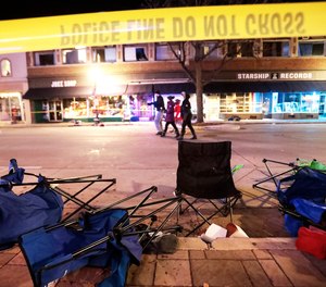 Toppled chairs line W. Main St. in downtown Waukesha, Wis., after an SUV drove into a parade of Christmas marchers Sunday, Nov. 21, 2021.