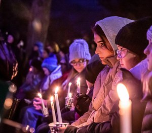 People gather in Waukesha's Cutler Park for a candlelight vigil for those affected by the Waukesha Christmas Parade tragedy, Monday, Nov. 22, 2021 in Waukesha, Wis.