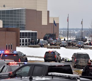 Dozens of police, fire, and EMS personnel work on the scene of a shooting at Oxford High School, Tuesday, Nov. 30, 2021, In Oxford Township, Mich.