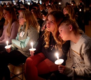 Students comfort each other as they listen to Jessi Holt, pastor at LakePoint Community Church, during a prayer vigil at the church after the Oxford High School school shooting, Tuesday, Nov. 30, 2021, in Oxford, Mich.