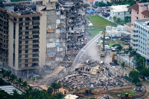 Rescue personnel work at the remains of the Champlain Towers South condo building, June 25, 2021, in Surfside, Fla.
