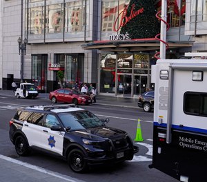 Police vehicles are stationed at Union Square following recent robberies in San Francisco, Thursday, Dec. 2, 2021. In San Francisco, homeless tents, open drug use, home break-ins and dirty streets have proliferated during the pandemic. The quality of life crimes and a laissez-faire approach by officials to brazen drug dealing have given residents a sense the city is in decline.