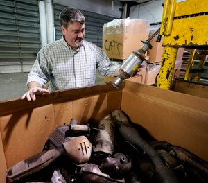 Troy Webber, owner of Chesterfield Auto Parts, holds a used catalytic converter that was removed from one of the cars at his salvage yard Friday Dec. 17, 2021, in Richmond, Va.