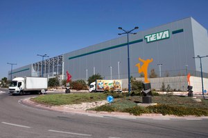 Trucks drive in front of Teva Pharmaceutical Logistic Center in the town of Shoam, Israel, Oct. 16, 2013.