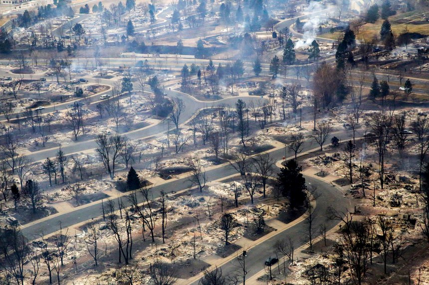 A view of a Boulder County neighborhood that was destroyed by a wildfire is seen from a Colorado National Guard helicopter during a flyover by Gov. Jared Polis on Friday, Dec. 31, 2021. Tens of thousands of Coloradans driven from their neighborhoods by a wind-whipped wildfire anxiously waited to learn what was left standing of their lives Friday as authorities reported more than 500 homes were feared destroyed.